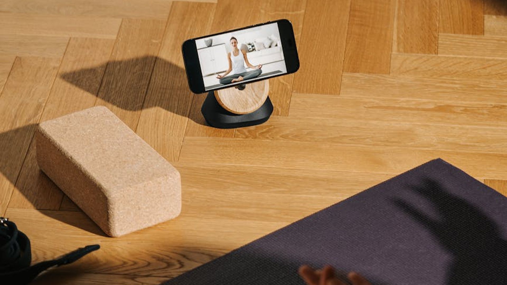 Serene yoga studio with natural light and wooden floor.
